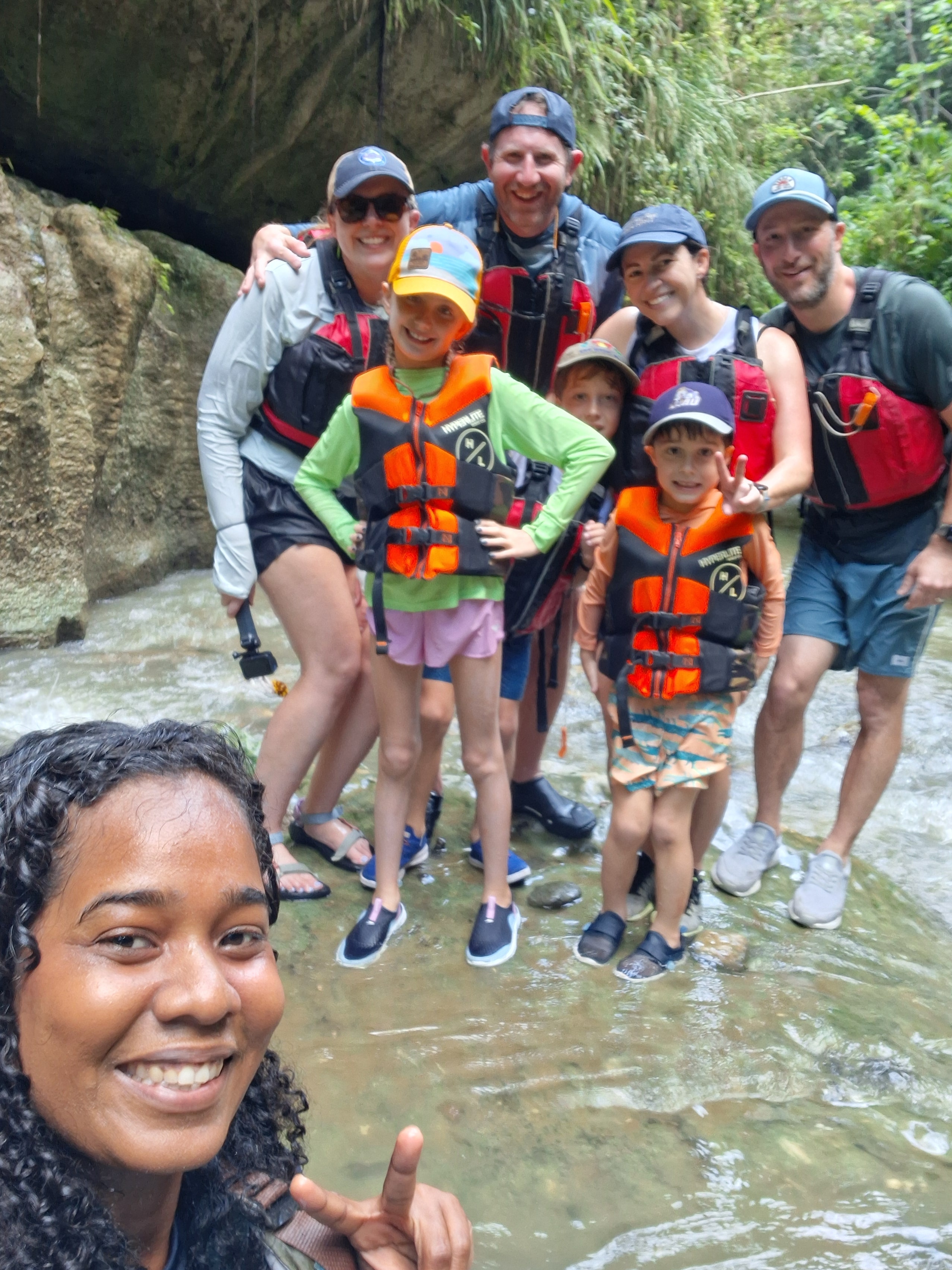 Tour group with life vests celebrating inside the karst canyon