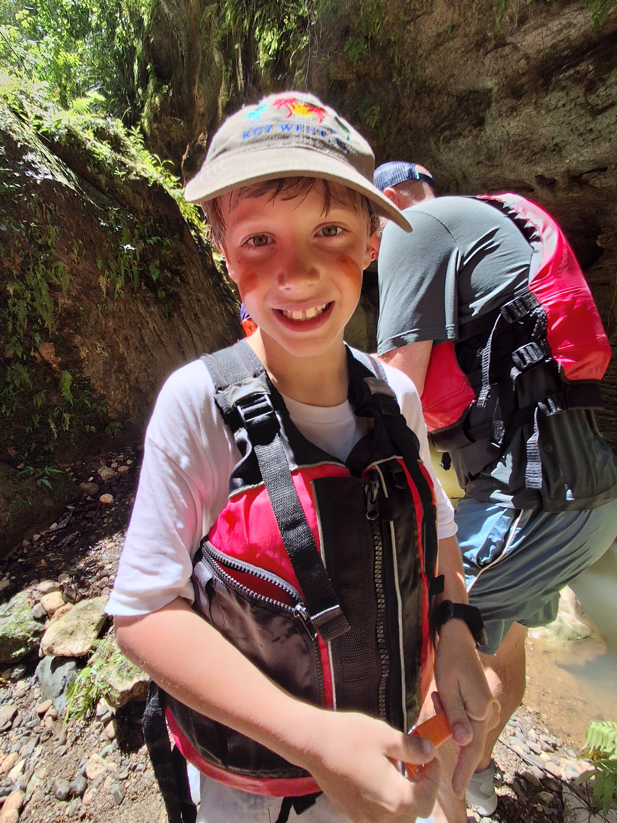 Young adventurer smiling on the karst trail