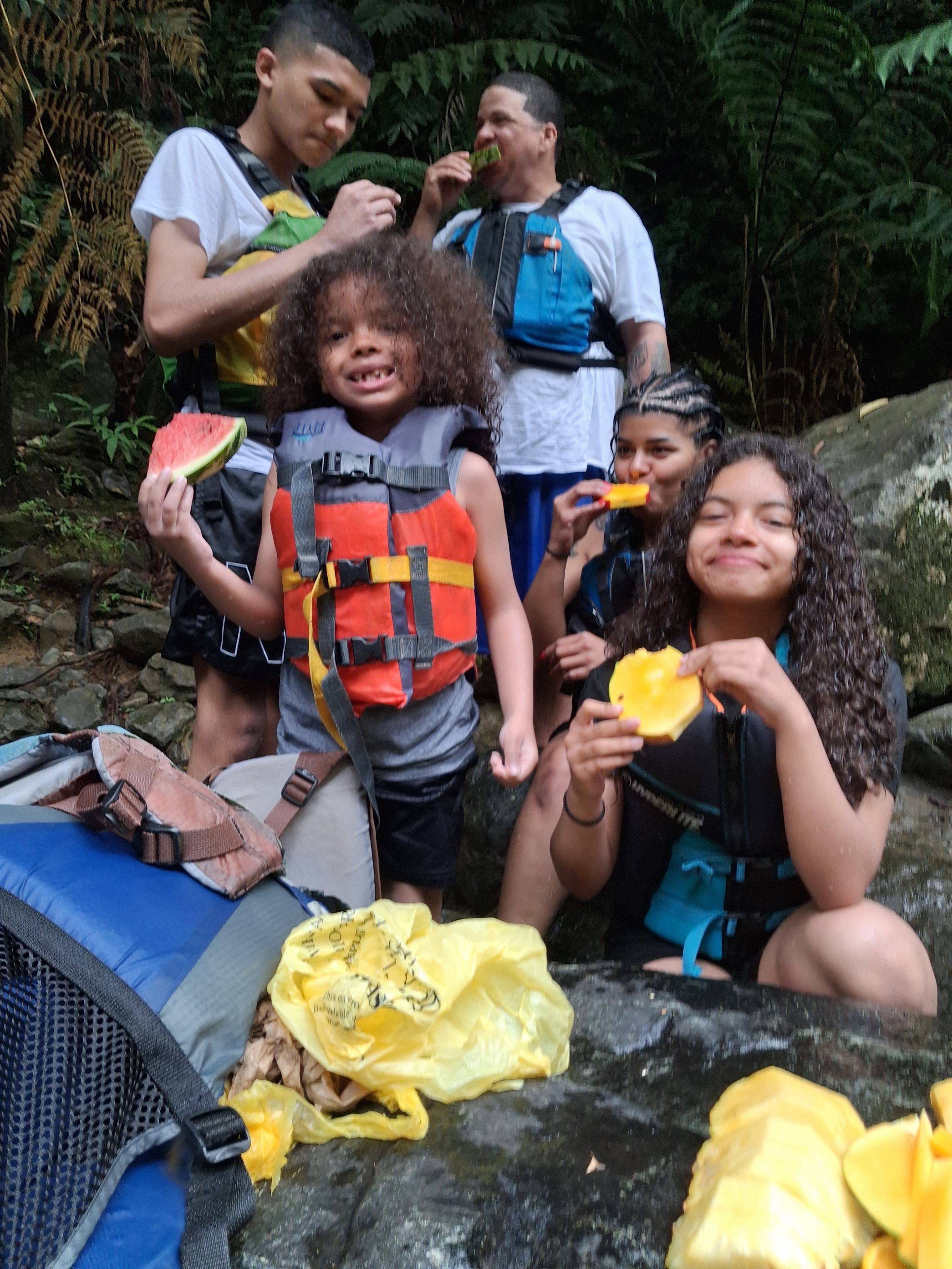 Kids with life vests enjoying a snack break on the trail