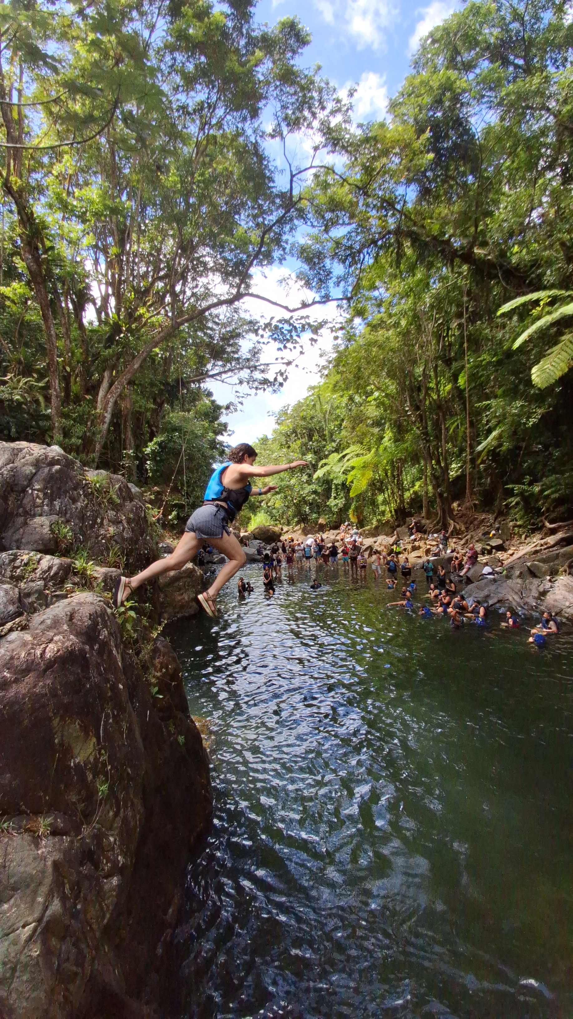 Guest cliff jumping into the jungle river pool